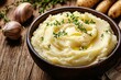 © ckybe - Rich and velvety mashed potatoes served in a charming bowl, topped with vibrant herbs and a splash of warm butter, poised to enhance any dish.