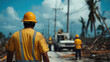 © M - Construction workers in yellow helmets and shirts collaborate on a roadway restoration project amidst debris under a blue sky