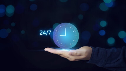 Businessman's hands holding virtual 24-7 with clock on hand For non-stop and full-time contact customer service