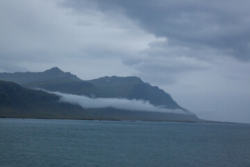 Iceland mountain at the shore with clouds