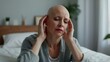 © Artem - Bald Woman with Headache After Chemotherapy - Cancer Treatment and Healthcare Concept