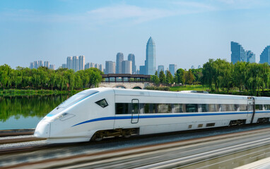 Fototapete - High-speed rail speeds on Bridges and the modern city skyline of shaoxing, zhejiang,China