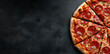 © Sascha - A slice of pepperoni pizza is on a black background
