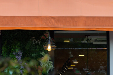 Sticker - A lighted lamp hangs from the ceiling of a restaurant