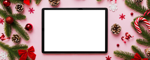 Wall Mural - Top view of empty tablet on Christmas background made of new year decorand festive decorations. New year holiday concept. Mockup