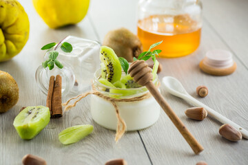 Poster - Homemade yogurt in a glass jar with honey, kiwi, nuts.