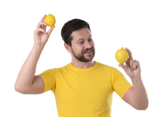 Wall Mural - Happy man holding lemons on white background