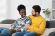© New Africa - International relationships. Lovely couple spending time together at home