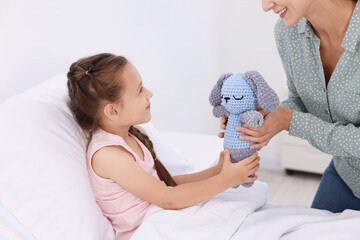 Wall Mural - Mother and her little daughter on bed in hospital