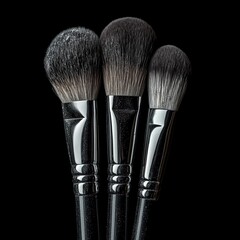 Make-up brushes with powder isolated on black background