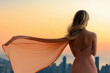 © Gyorgy - Fashion model elegantly posing on a balcony overlooking a city skyline, wearing a flowing dress with the wind gently moving the fabric