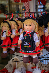 Wall Mural - Colmar, France - June 5, 2023: Children s toys, Alsatian souvenir dolls in traditional folk outfits on display at a store in the old town