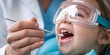 © hobonski - Close-up of a dentist applying a fluoride treatment to a child's teeth using a small brush. The child is wearing protective goggles, and the dentist’s hand is steady.