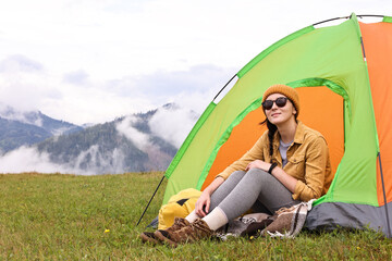 Sticker - Young camper and tent in mountains. Active tourism