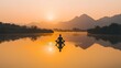 © logyartstudios - A lone figure meditates in lotus position on a calm lake at sunrise, silhouetted against the rising sun and distant mountains.