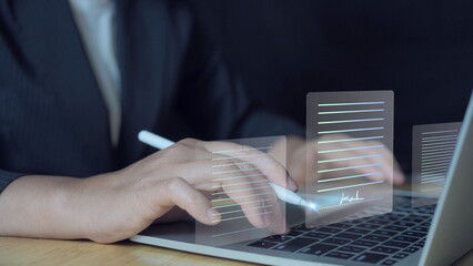 Electronic Signature Concept, Electronic Signing Businessman signs electronic documents on digital documents on virtual laptop screen using stylus pen.