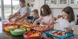 © hobonski - A view from above as the family makes homemade pizza on the kitchen island. Toppings like cheese, tomatoes, peppers, and olives are spread out in colorful bowls.