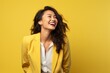 © Markus Schröder - Portrait of a joyful asian woman in her 30s dressed in a stylish blazer isolated on soft yellow background