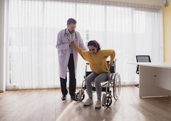 Health care latin woman sick sit wheelchair with man doctor caucasian two people check and treat patients talk help support explain medicine sick person in take care your health hospital clinic room.