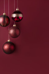 Wall Mural - Burgundy, Wine, Garnet, Carmine, scarlet, berry, burgundy, Christmas background with burgundy Christmas glass ornaments with gold elements on a wine-colored background with copy space.