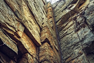 Poster - A Close-Up View of a Rugged Rock Face with a Chain