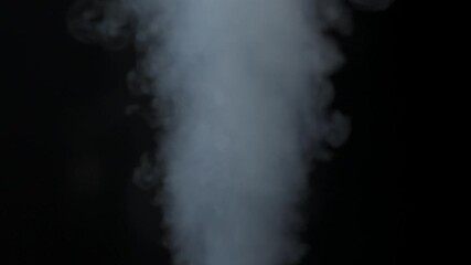 Wall Mural - close-up of white smoke clouds against a black background. contrast of brightly lit smoke and dark r