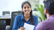 © colnihko - Smiling professional Indian woman conducting business interview in modern office