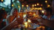 © Alienmarsh - Friends toasting with glasses of sparkling drinks in a warm, festive setting.