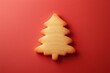 © Images - A minimalist depiction of a Christmas cookie shaped like a tree on a plain background