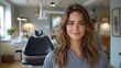 © Рудой Максим - A young woman smiles confidently in a modern dental office during a routine check-up appointment in a bright, inviting environment