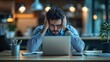 © CreativeVista - Exhausted Office Worker Struggling with Work Stress While Using Laptop in Dimly Lit Workspace, Showing Anxiety and Burnout
