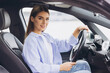 © anatoliycherkas - Confident Young Woman Sitting Behind the Wheel of a Car in a Relaxed Pose