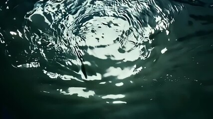Aufkleber - The rippling water surface creates abstract shapes and reflects sunlight with an emerald green tone, adding a dynamic pattern to the background