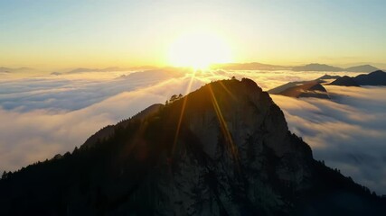Poster - Capturing a stunning sunrise over a mountain peak, with warm sunlight and clouds creating a serene atmosphere