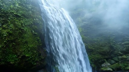 Poster - Water cascading down moss covered rocks in a serene nature landscape with a beautiful waterfall, surrounded by greenery, creating a peaceful spot to explore