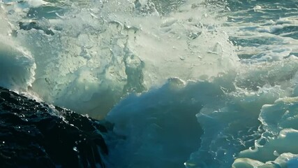 Poster - Mesmerizing ocean waves crash and churn, creating white sea foam with light shining through crystal clear water. Blue and green hues blend in a breathtaking seascape, showcasing nature's raw power