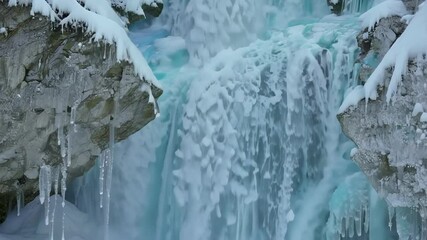 Aufkleber - Water flows over the edge of a rocky cliff face, freezing as it falls, creating a beautiful wall of ice with icicles hanging down
