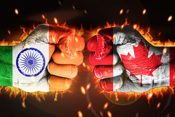 India Vs Canada clash concept background with painted fist and glowing fire behind, backdrop. Canada vs India hands with flag painted