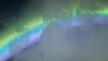 Poster - The colorful aurora borealis lights up the night sky in green and purple hues, creating a magical atmosphere