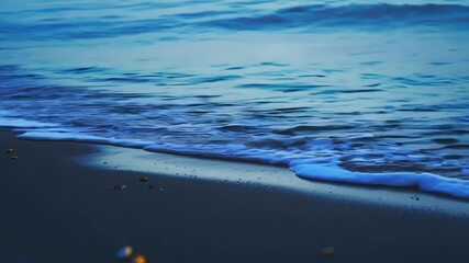 Aufkleber - Soft blue waves gently lap on sandy beach at twilight, creating peace and tranquility. Serene ocean meeting shore is perfect for relaxation and meditation