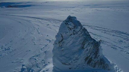 Aufkleber - Majestic mountain peak covered in fresh powder casts a long shadow on a sunny ski slope, exuding tranquility and serenity in the vast alpine wilderness