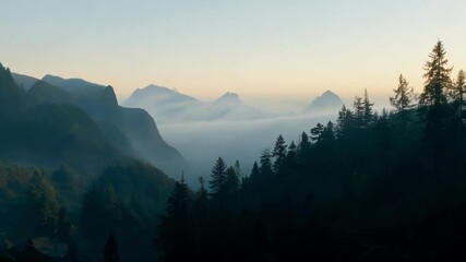 Aufkleber - The sun is rising over a mountain valley filled with low clouds and hazy light, creating a mysterious and awe inspiring scene