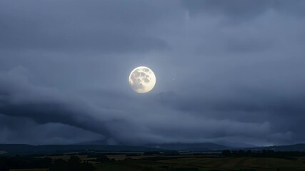 Poster - Bright full moon glows in a dark sky with storm clouds over a peaceful rural landscape, creating a moody and serene atmosphere. Mesmerizing celestial beauty perfect for backgrounds