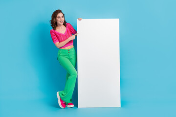 Wall Mural - Full length photo of pretty cute lady wear pink retro clothes presenting empty space modern device isolated on blue color background