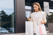 © anatoliycherkas - Young Woman Shopping with Bags on a Sunny Day Outdoors