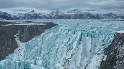 Aufkleber - Marvel at the turquoise glacier melting against snow capped mountains on a cloudy day, a stunning mix of blue and white in a remote arctic wilderness