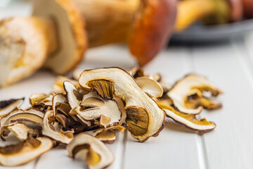 Wall Mural - Dried porcini mushrooms. Sliced boletus on white table.