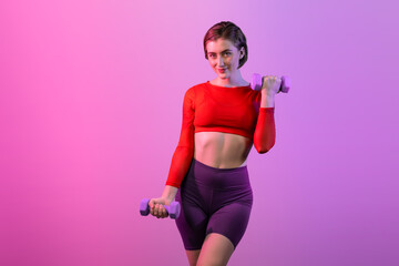 Full body length gaiety shot athletic and sporty woman with dumbbell for weight lifting as bodybuilding exercise in standing posture on isolated background. Healthy active and body care lifestyle