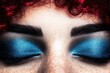 © Konstiantyn Zapylaie - Vivid blue eyeshadow on freckled skin with red curly hair close-up