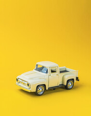 Toy truck is sitting on a yellow background